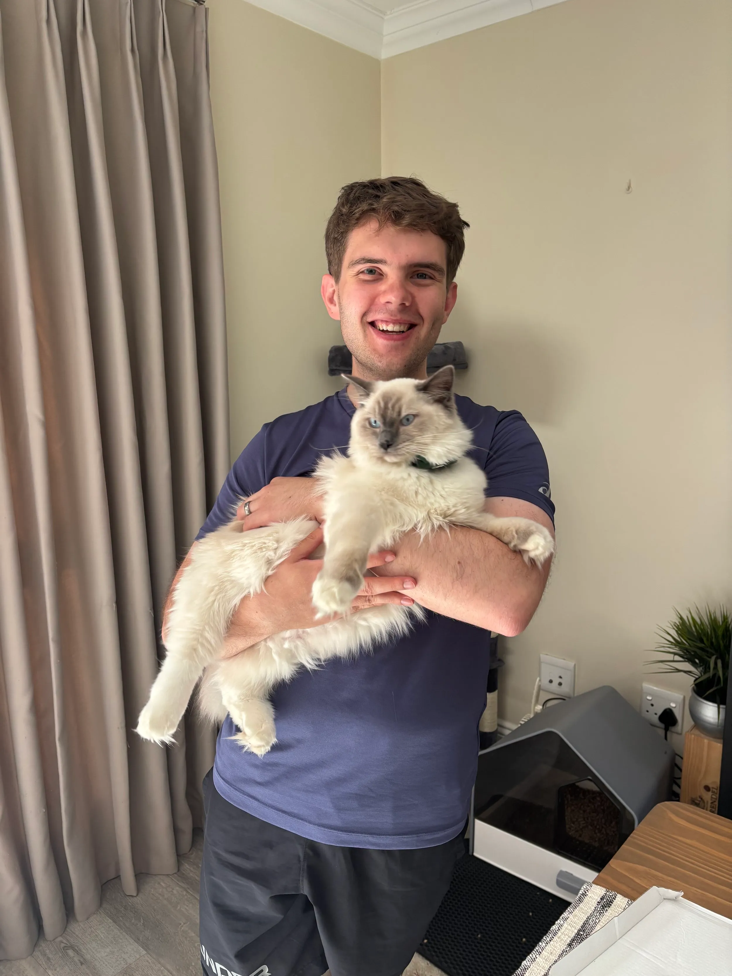 Dehan Lamprecht holding a Siamese cat